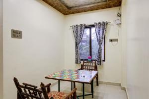 a dining room with a table and chairs and a window at Mountain Paradise Villa in Jāmb