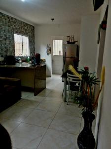 a large kitchen with a table and a refrigerator at Casa na praia com 2 quartos in Itanhaém