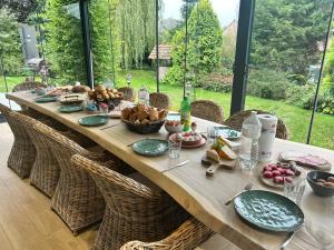 a long wooden table with food on top of it at La Maison de Rose in Riemst
