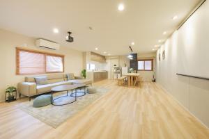 a living room with a couch and a table at Breeze Stay Shiohama in Tokyo