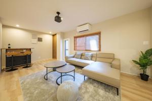 a living room with a couch and a table at Breeze Stay Shiohama in Tokyo