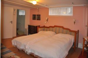 a bedroom with a large bed with a wooden headboard at Orkelljunga guestroom in Orkelljunga