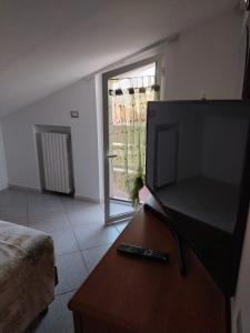 a living room with a large flat screen tv on a table at Carmenhouse in Montesilvano
