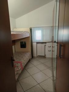 a small room with a bed and a window at Carmenhouse in Montesilvano
