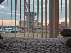 a bedroom with a bed and a view of an airport at Apartament KONGRESOWA VIEW in Kielce