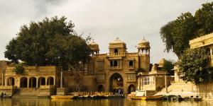 an old building with boats in the water at Hotel Shahiraj Jaisalmer in Jaisalmer