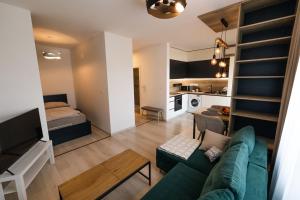 a living room with a couch and a bed in a room at Cloud 9 in Bratislava