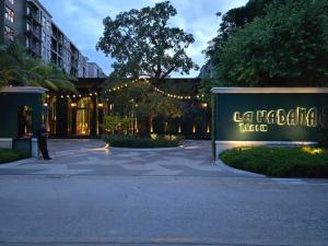 a man standing in front of a building at night at La Habana Huahin by J2A in Hua Hin