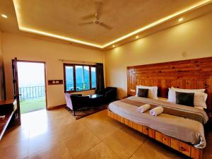 a bedroom with a large bed and a chair in it at Cliff On The Edge - A Premium Property in Mussoorie