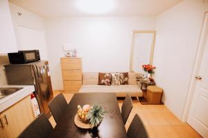 a kitchen with a table and chairs in a room at San Remo Condo in Cebu City