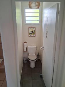 a small bathroom with a toilet and a window at Belle Villa 3 chambres piscine Rivière Salée in Rivière-Salée +5 photos