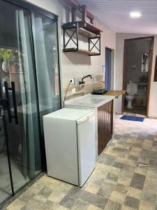 a kitchen with a sink and a counter top at Hostel Sossego do Garças in Barra do Garças