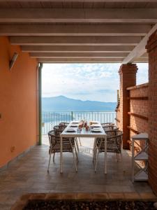 a table and chairs on a patio with a view at Casa Raki in Parzanica
