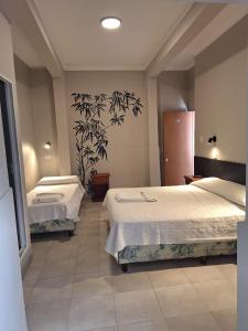 Ένα ή περισσότερα κρεβάτια σε δωμάτιο στο Hotel Marilian II