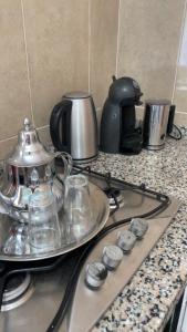 a stove top with a tea pot on a counter at Aqoua private villa in Tétouan
