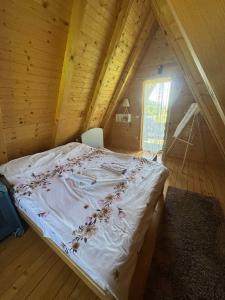 a bedroom with a bed in a wooden attic at Monte Casa in Ivišovo Greblje
