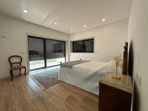 a bedroom with a bed and a large window at MiraReal Guest House  +18 photos