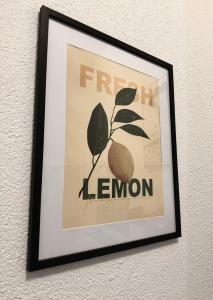a framed picture of a lemon on a wall at Ruhige Wohnung am Bahnhof - gemütlich, zentral, mit Küche in Bamberg +4 photos