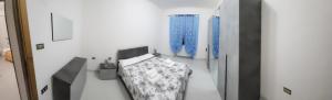 a room with a bed and some blue vases at Casa Valeria in Sulmona