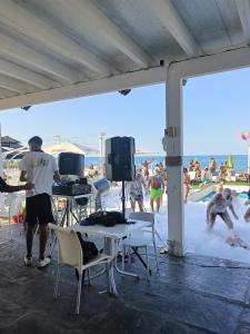 a group of people playing in the water at the beach at LA TERRAZZA SUL MARE camera fronte mare&vicino aereoporto SICILIAN VINTAGE STYLE SEASIDE ROOM in Cinisi