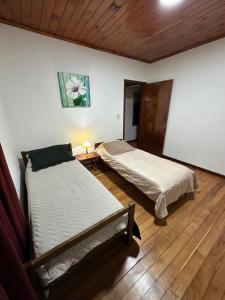 a bedroom with two beds and a table with a lamp at La Rosa House - Central house in Eldorado in Eldorado