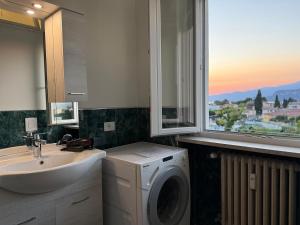 a bathroom with a washing machine and a sink at Bella vista - Garda Lake in Bardolino +25 photos