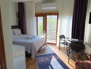 a small bedroom with a bed and a balcony at NarPera Taksim Boutique Hotel in Istanbul