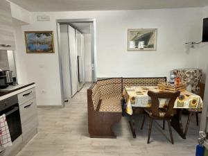 a kitchen with a dining room table and a table and chairs at Borgo Antico in Gamberale