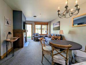 a living room with a table and a couch at Springs 8806 by SummitCove Lodging in Colorado in Keystone