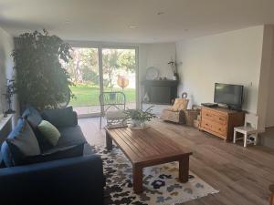 a living room with a couch and a coffee table at Between city and countryside in Maisons-Laffitte