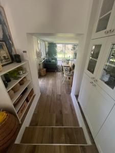 a hallway of a home with a hard wood floor at Between city and countryside in Maisons-Laffitte