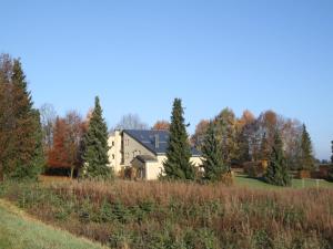 a house in the middle of a field with trees at Holiday Home in Gros Fays with Garden in Gros-Fays +32 photos