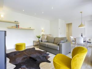 a living room with a couch and chairs and a table at Holiday Home in Gros Fays with Garden in Gros-Fays