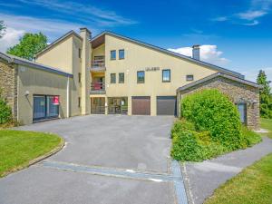 a building with a parking lot in front of it at Holiday Home in Gros Fays with Garden in Gros-Fays