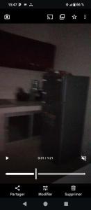 a television screen with a picture of a microwave at Appartement meublés de luxe in Dakar