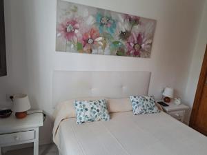 a bedroom with a bed with two pillows on it at Tabaiba Place in Tías