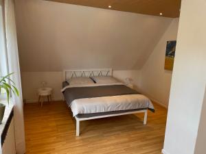 a bedroom with a large bed in a room at Ferienhaus Söten Wind in Upgant-Schott +3 photos