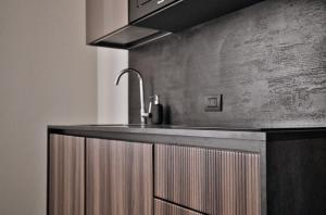a kitchen with a sink and a counter top at Luxury Design Apartment-2 Steps from Duomo in Milan