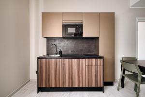a kitchen with a sink and a microwave at Luxury Design Apartment Duomo in Milan