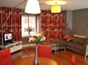 a living room with a couch and a table at Dreamhouse Apartments Glasgow City Centre in Glasgow