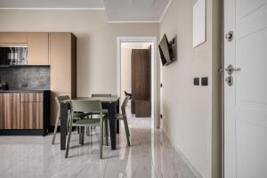 a kitchen and dining room with a table and chairs at Luxury Design Apartment-2 Steps from Duomo in Milan +11 photos