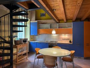 a kitchen with blue cabinets and a table and chairs at Borgo Santa Maria in Nembro