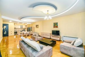 a large living room with couches and a television at Bakı Rezidens Apartment Nizami str in Baku