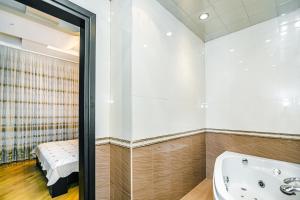 a bathroom with a tub and a bed in it at Bakı Rezidens Apartment Nizami str in Baku +84 photos