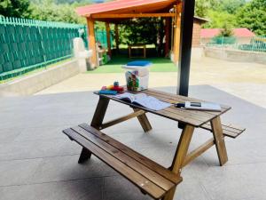 a wooden picnic table with a pen on it at Casa dello Sciatore Lorica in Lorica