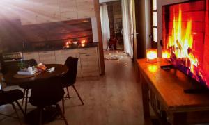 a kitchen with a table and a kitchen with a fireplace at Casa33 in Dobrovnik