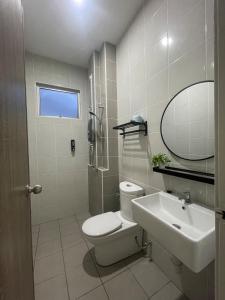 a bathroom with a toilet and a sink and a mirror at Simfoni Jitra Homestay in Jitra +31 photos