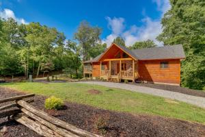 a cabin in the woods with a fence at Cabin Near Blue Ridge with Fire Pit and Large Deck in Mineral Bluff