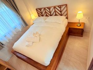 a bedroom with a bed with two towels on it at Srithanu Escape 3 in Ban Madua Wan
