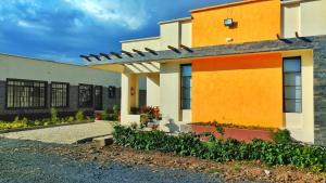a building with orange and white at Lamuria Naserian Villa in Nanyuki